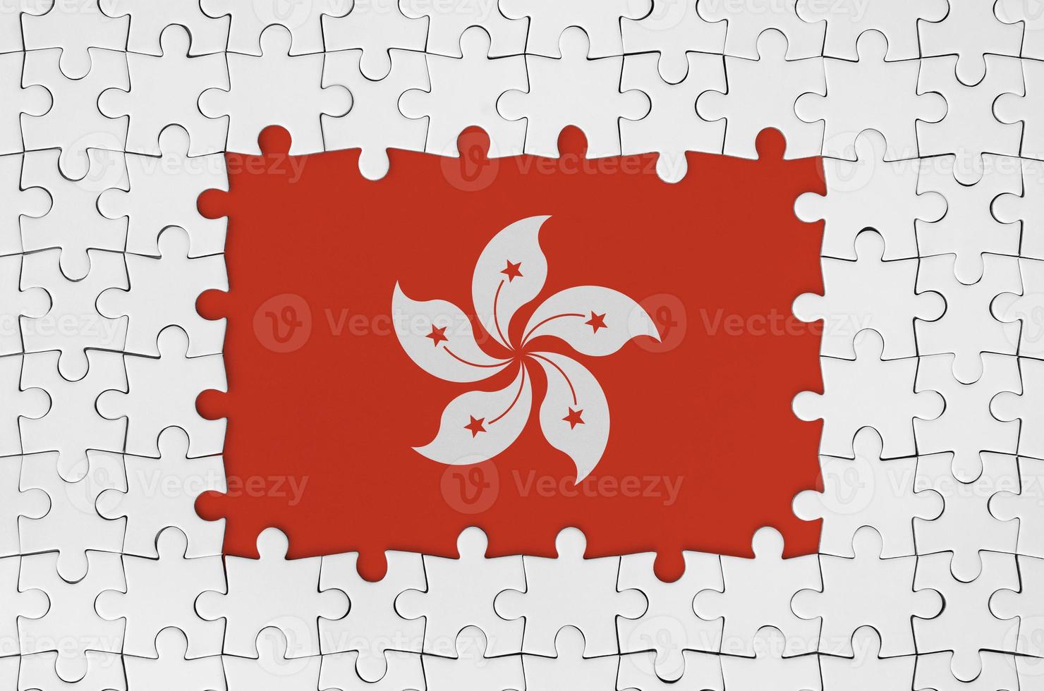 Hong kong flag in frame of white puzzle pieces with missing central part photo