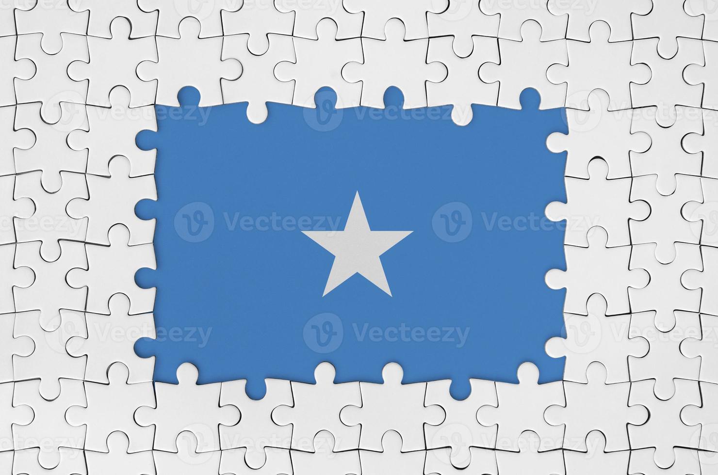 Somalia flag in frame of white puzzle pieces with missing central part photo