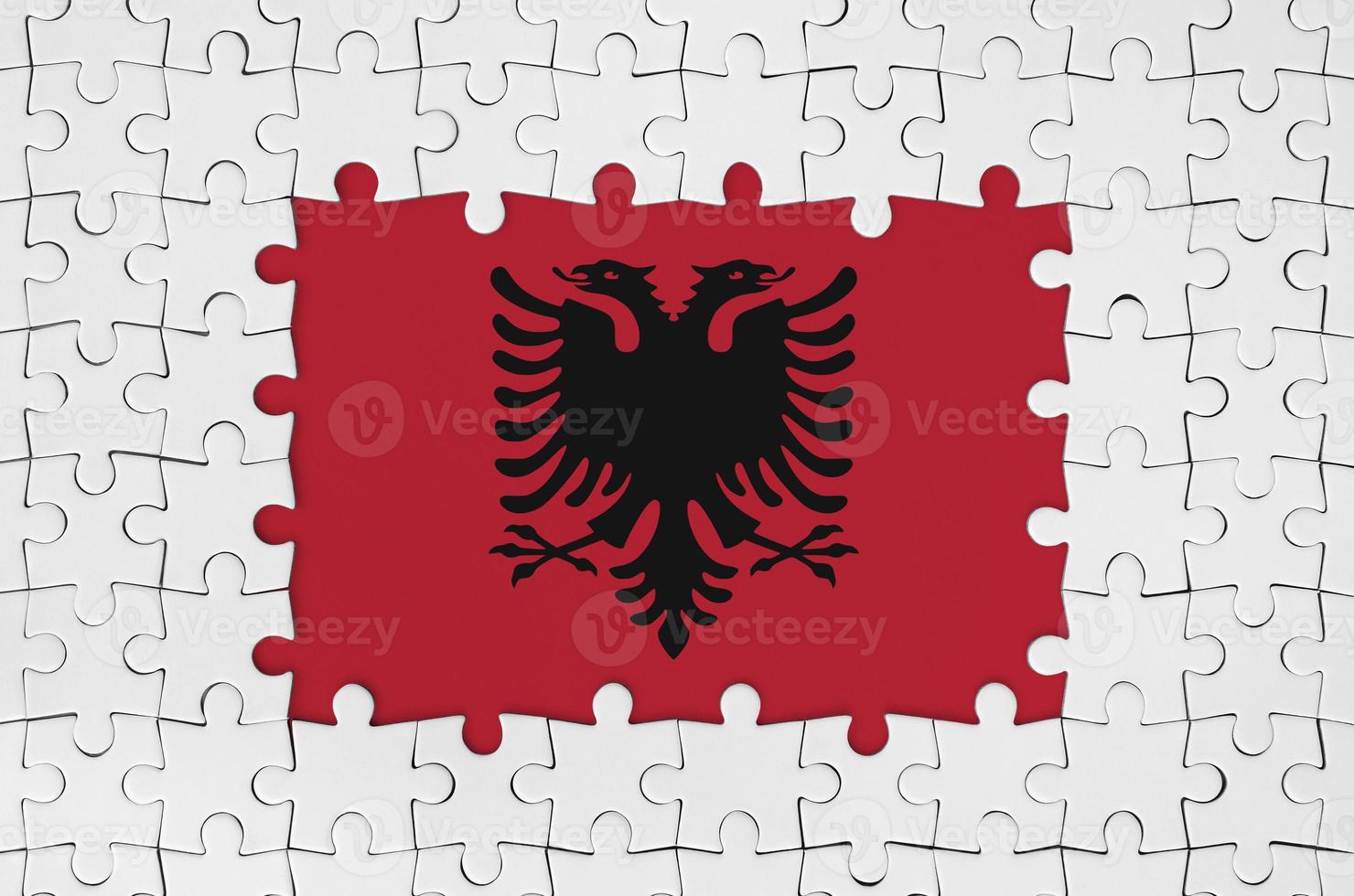 Albania flag in frame of white puzzle pieces with missing central part photo