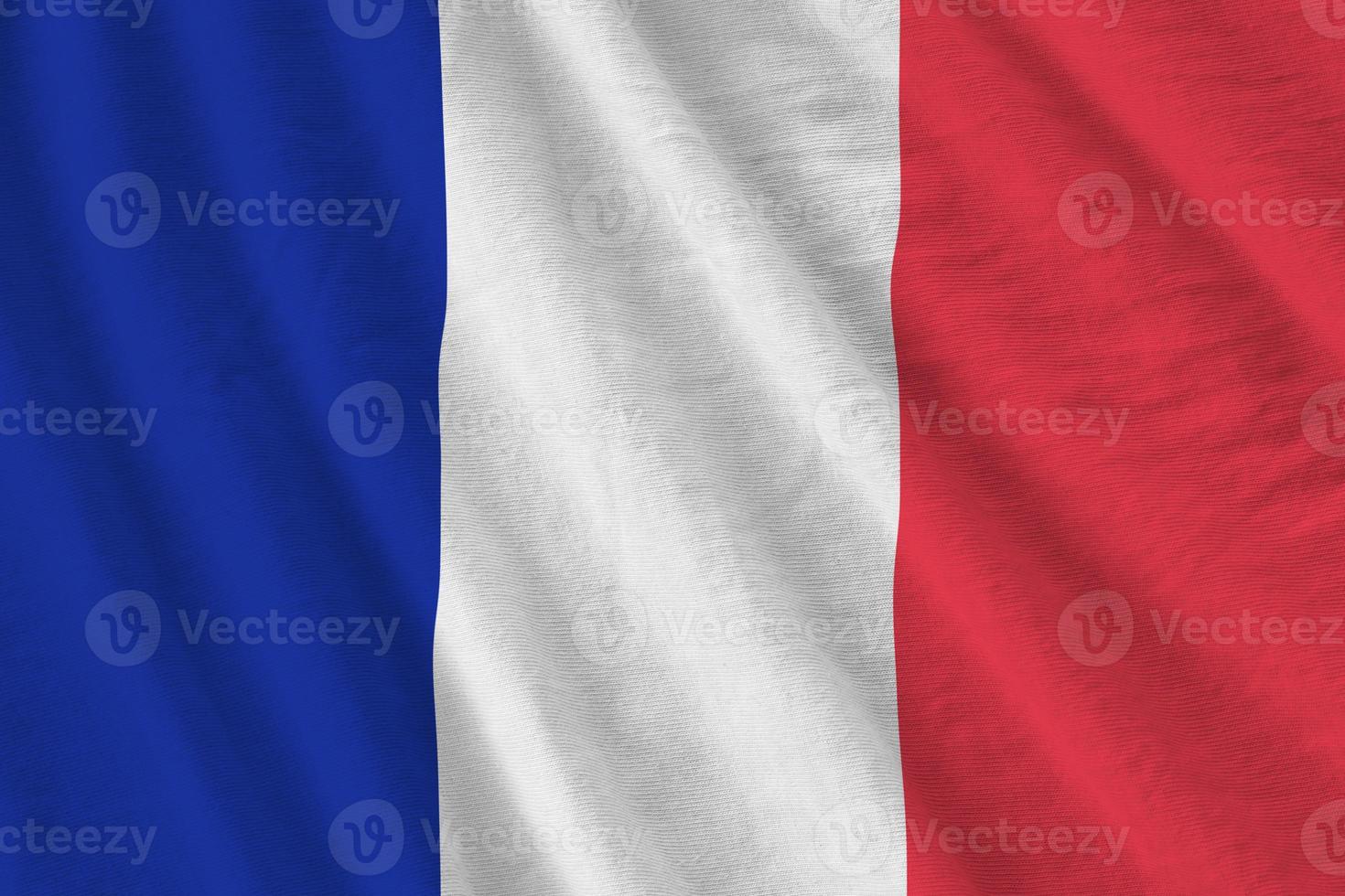 bandera de francia con grandes pliegues ondeando de cerca bajo la luz del estudio en el interior. los símbolos y colores oficiales en banner foto