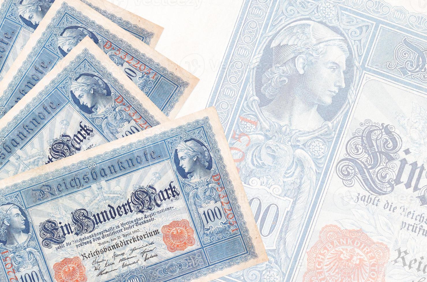 100 Reich marks bills lies in stack on background of big semi-transparent banknote. Abstract business background photo