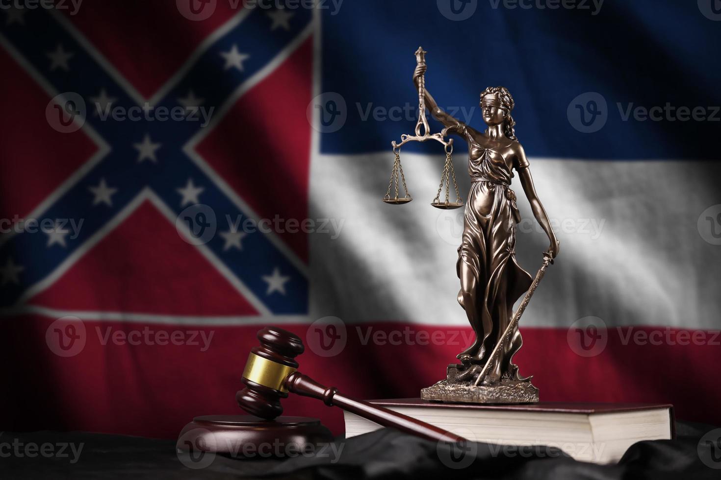 Mississippi new US state flag with statue of lady justice, constitution and judge hammer on black drapery. Concept of judgement and guilt photo