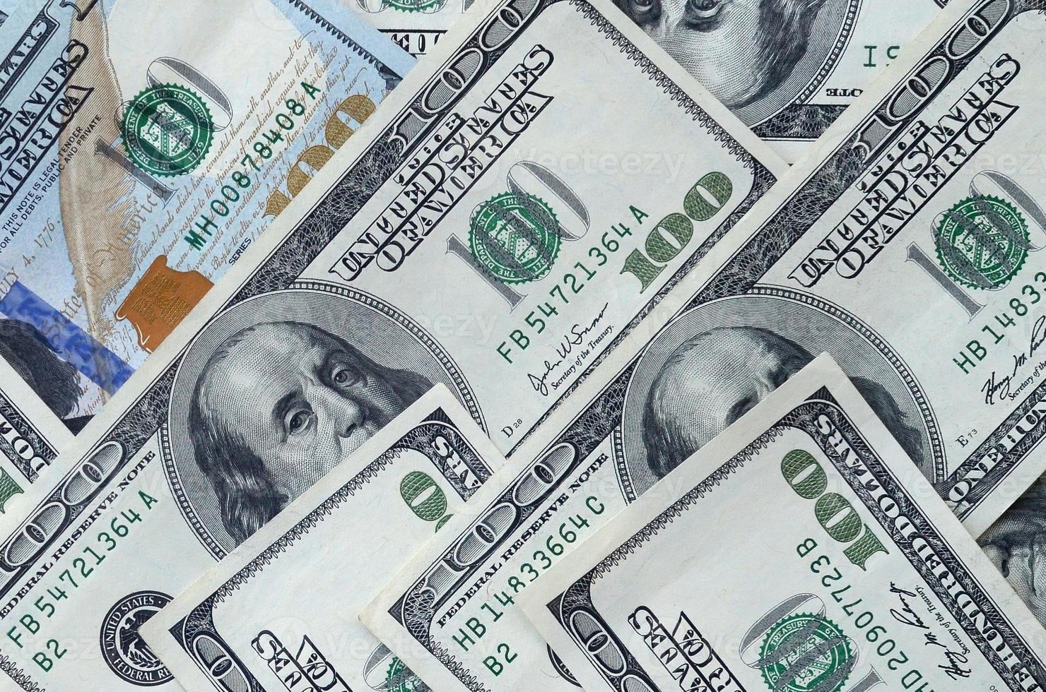 Abstract backdrop with many hundred dollar bills close up photo