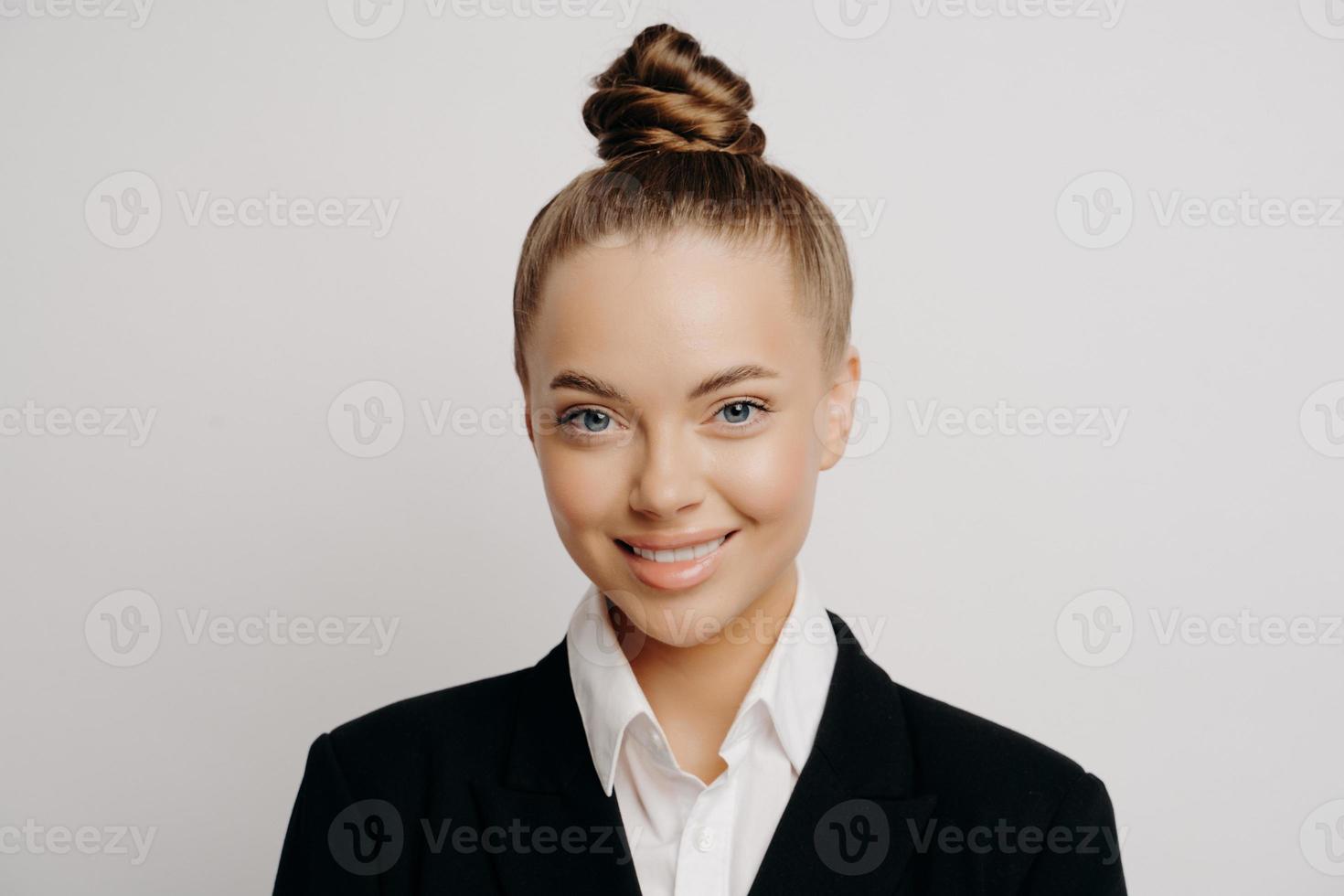 Smiling attractive business woman in dark suit photo