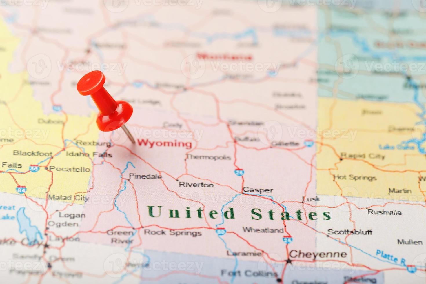Red clerical needle on a map of USA, Wyoming and the capital Cheyenne. Close up map of wyoming with red tack photo