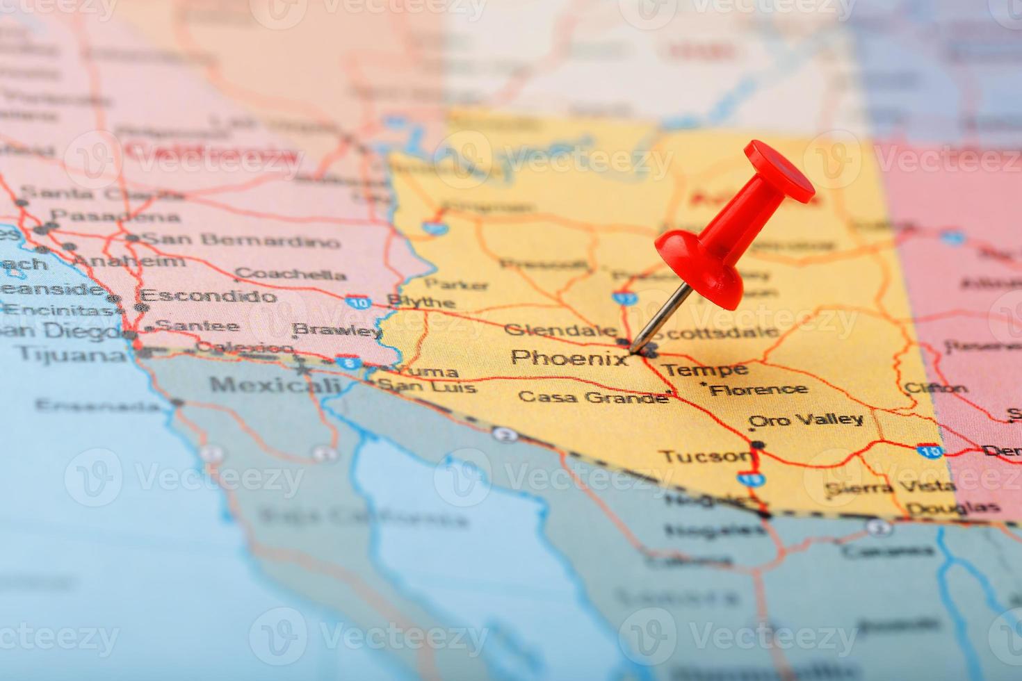 Red clerical needle on a map of the USA, Arizona and the capital Phoenix. Close up map of orizona with red tack photo