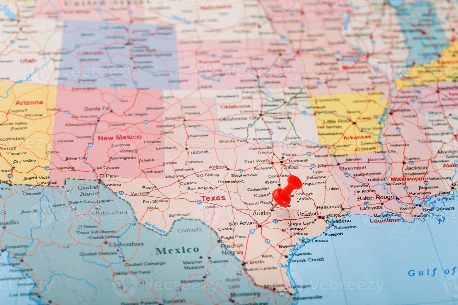 Red clerical needle on a map of USA, Texas and the capital Austin. Closeup Map Texas with Red Tack photo