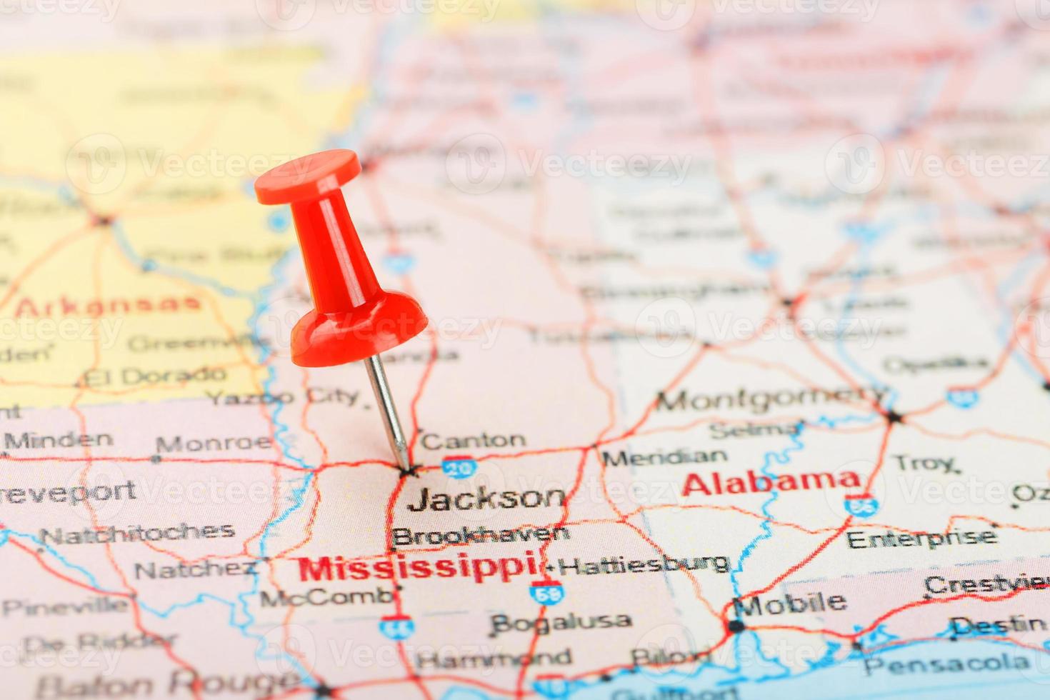Red clerical needle on a map of USA, South Mississippi and the capital Jackson. Close up map of South Mississippi with red tack photo