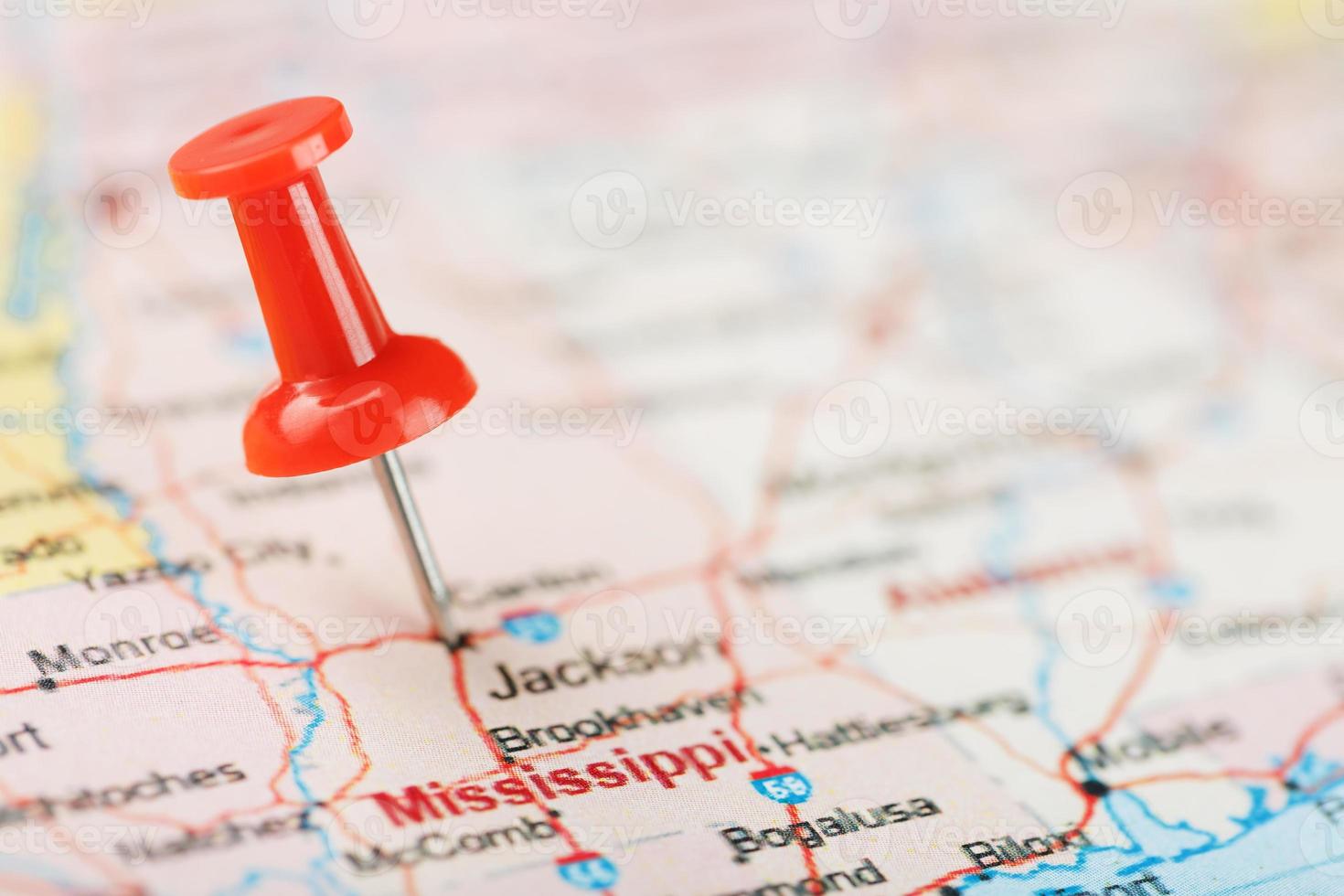 Red clerical needle on a map of USA, South Mississippi and the capital Jackson. Close up map of South Mississippi with red tack photo