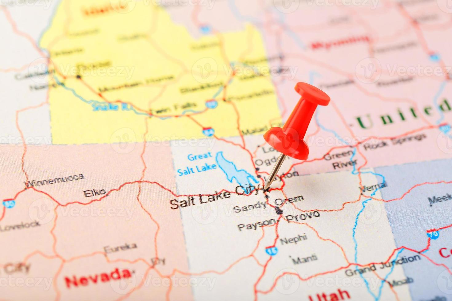 Red clerical needle on a map of USA, Utah and the capital Salt Lake City. Closeup Map Utah with Red Tack photo