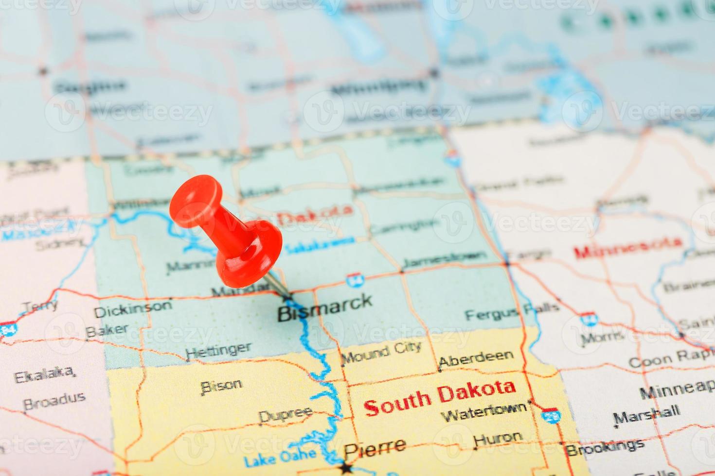 Red clerical needle on a map of USA, North Dakota and the capital Bismarck. Closeup Map North Dakota with Red Tack. United States photo