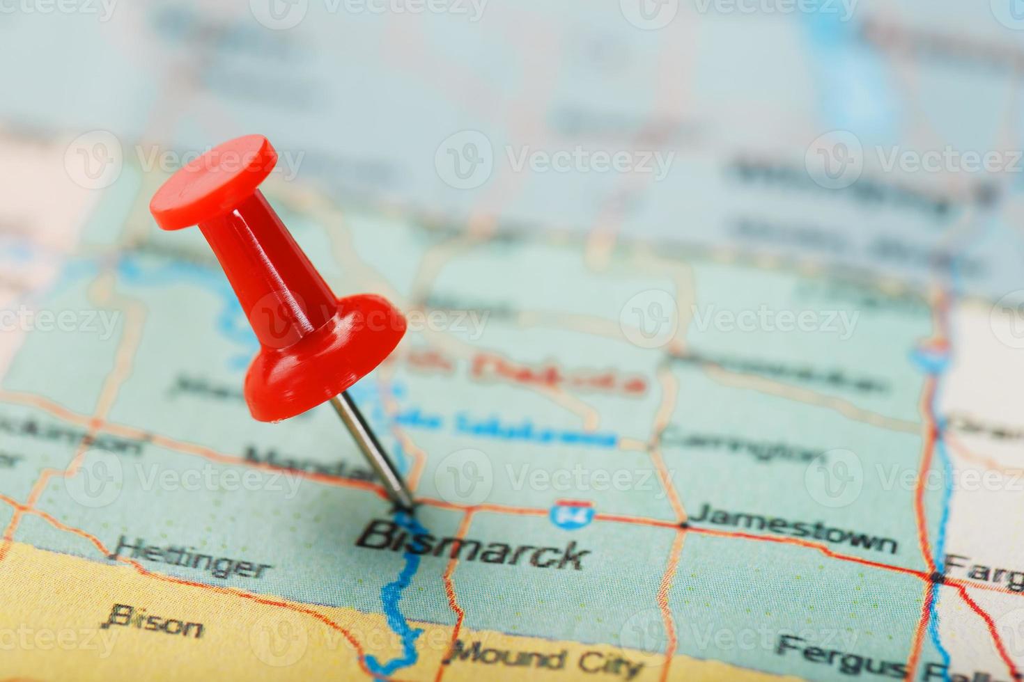 Red clerical needle on a map of USA, North Dakota and the capital Bismarck. Closeup Map North Dakota with Red Tack. United States photo