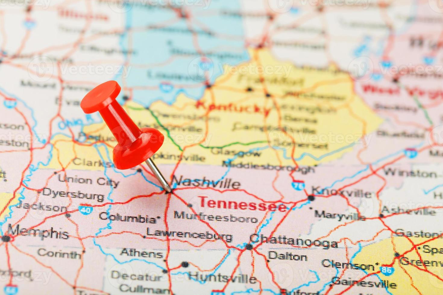 Red clerical needle on a map of USA, South Tennessee and the capital Nashville. Close up map of South Tennessee with red tack photo