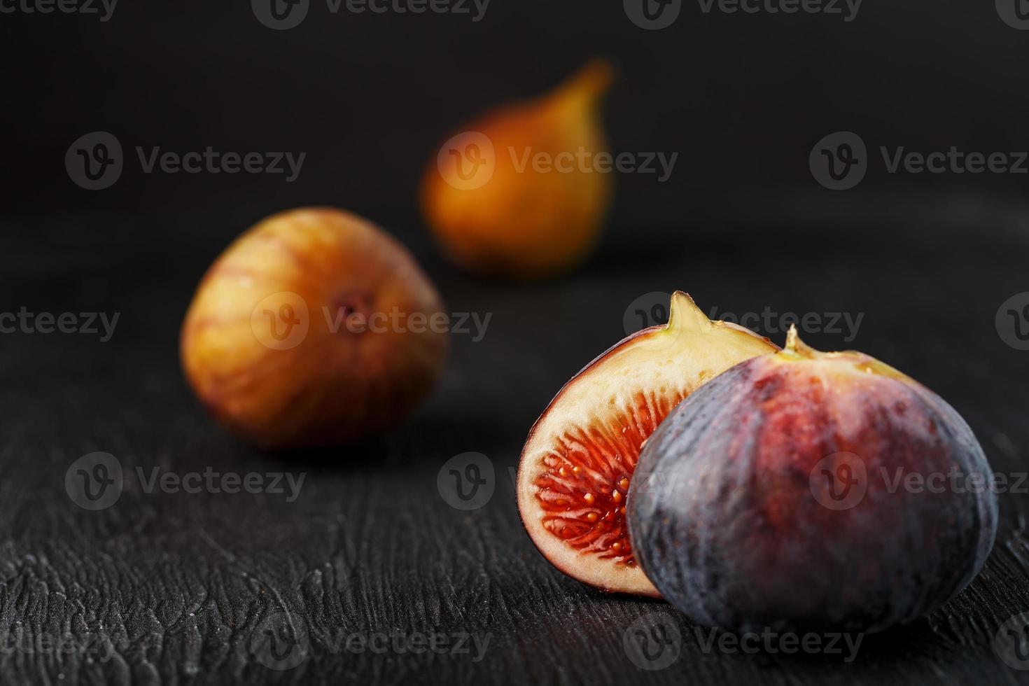 Juicy figs on a dark background, pulp of fig slices with seeds close-up. photo