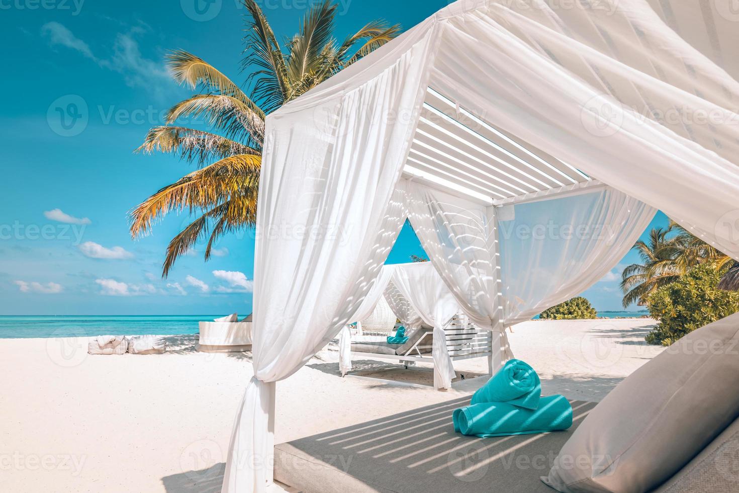 Amazing tropical beach scene with white canopy and curtain for luxury summer relaxation concept. Blue sky with white sand for sunny beach landscape background and summer vacation or holiday design photo