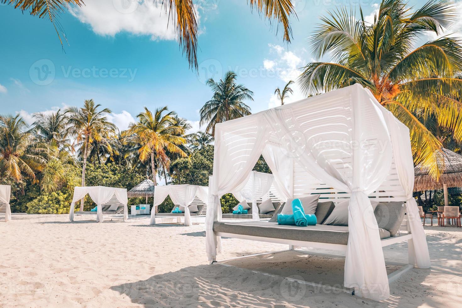 Amazing tropical beach scene with white canopy and curtain for luxury summer relaxation concept. Blue sky with white sand for sunny beach landscape background and summer vacation or holiday design photo