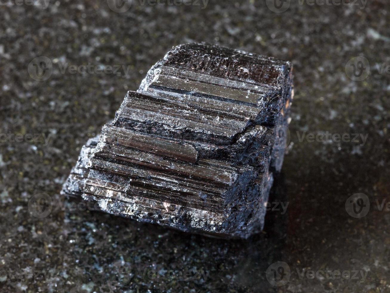 crystal of black Tourmaline Schorl on dark photo