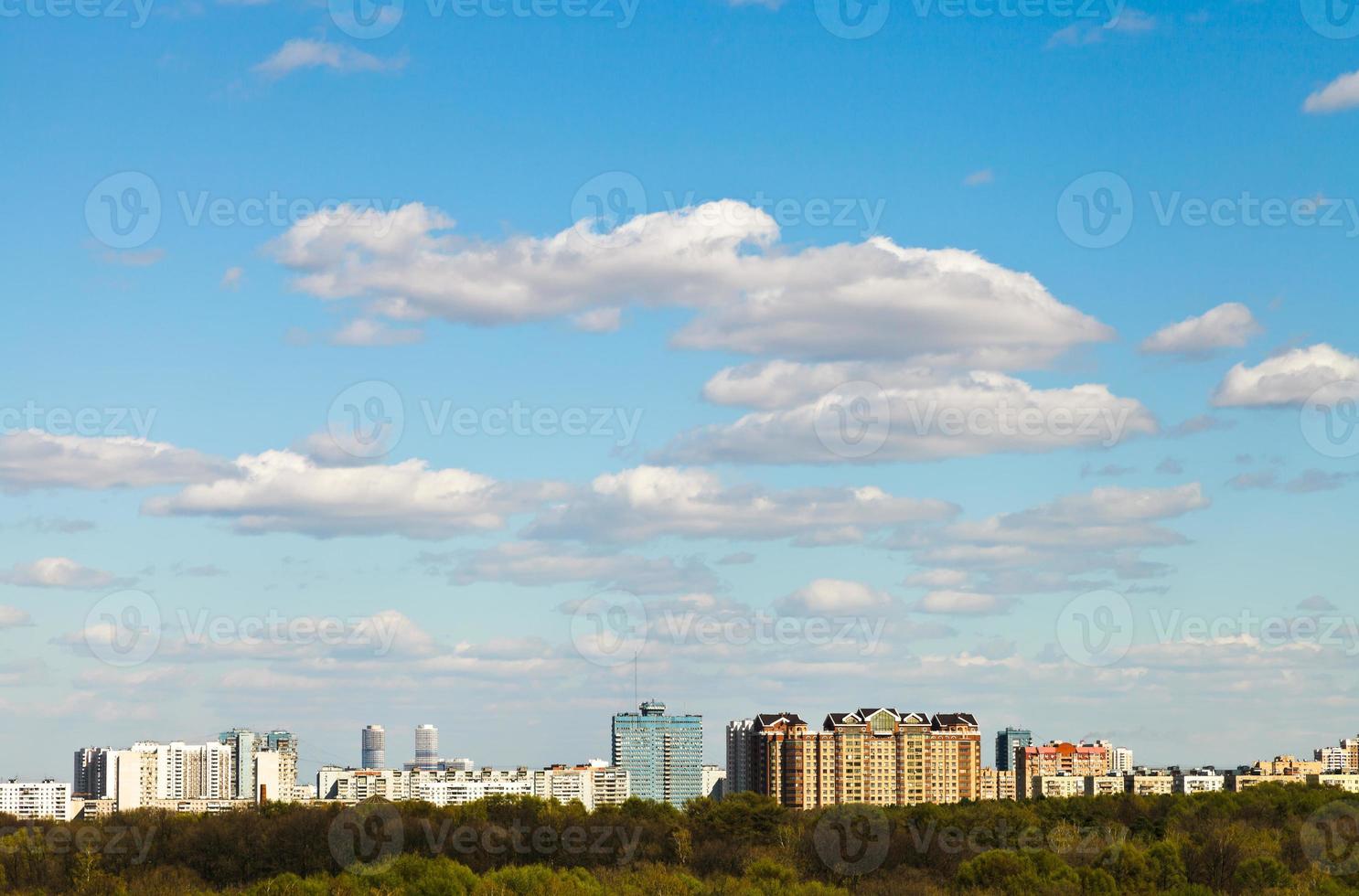 blue sky with clouds over residential district photo