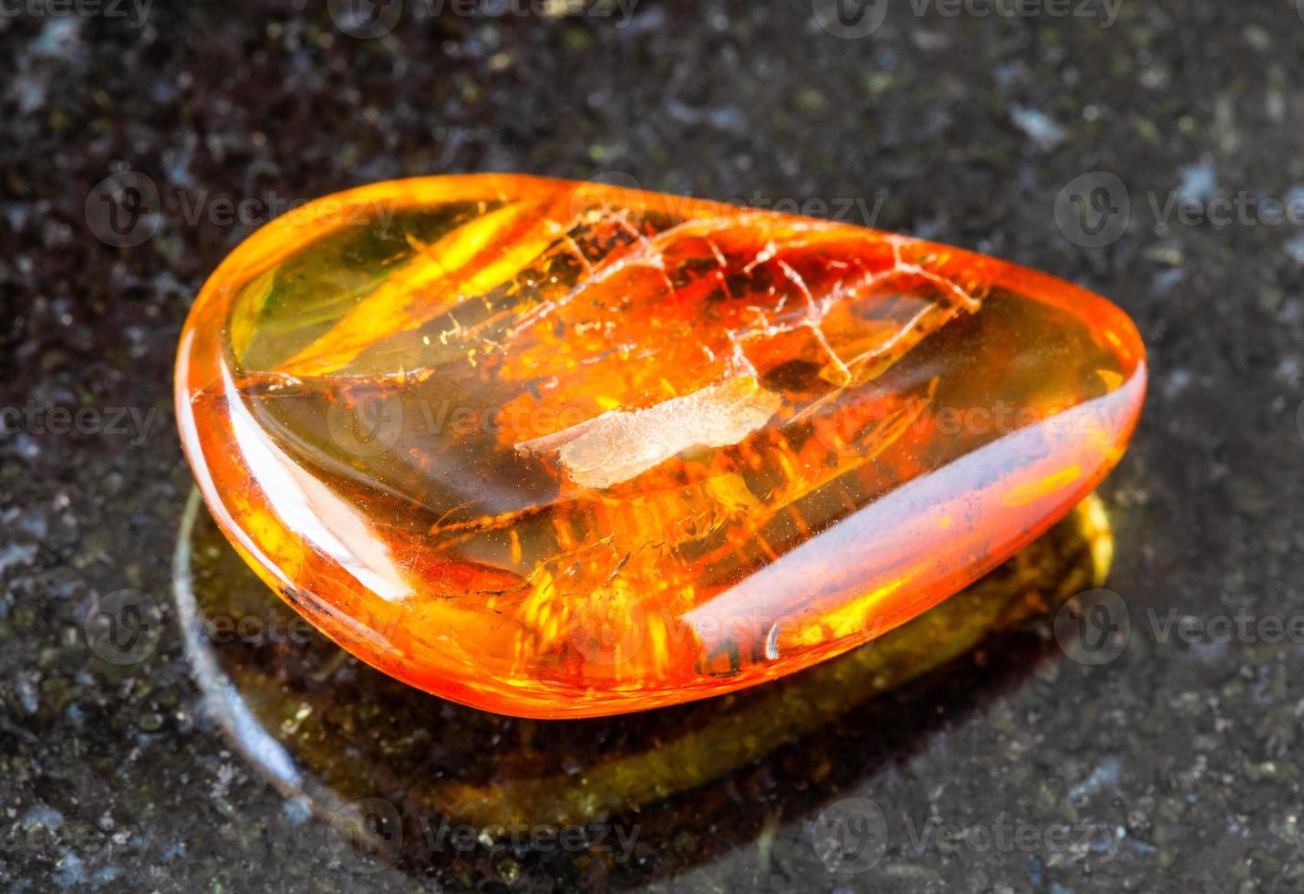 polished Amber gem stone on black photo