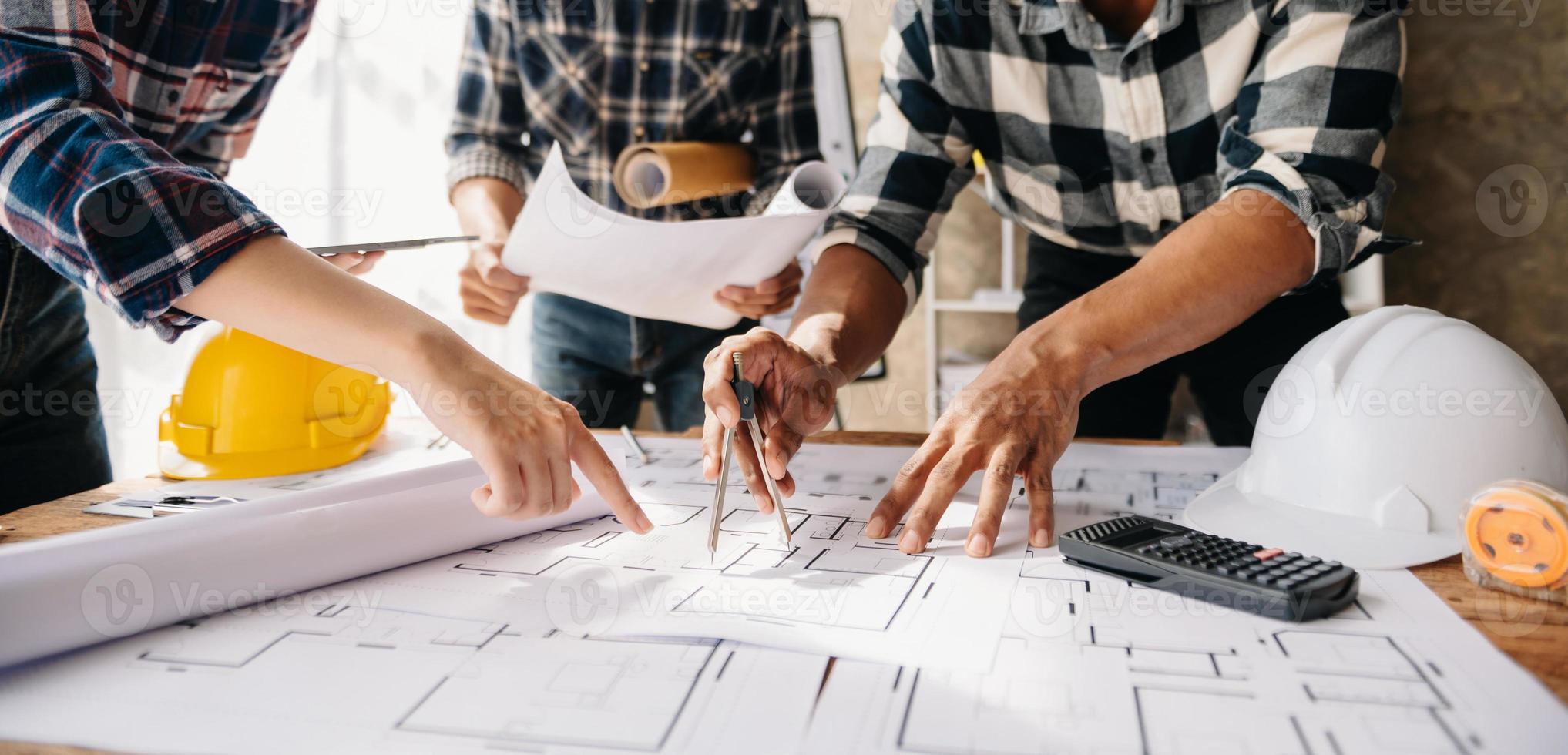 Engineer people meeting working in office for discussing, engineering .Hands of Engineer working on blueprint Construction concept. photo
