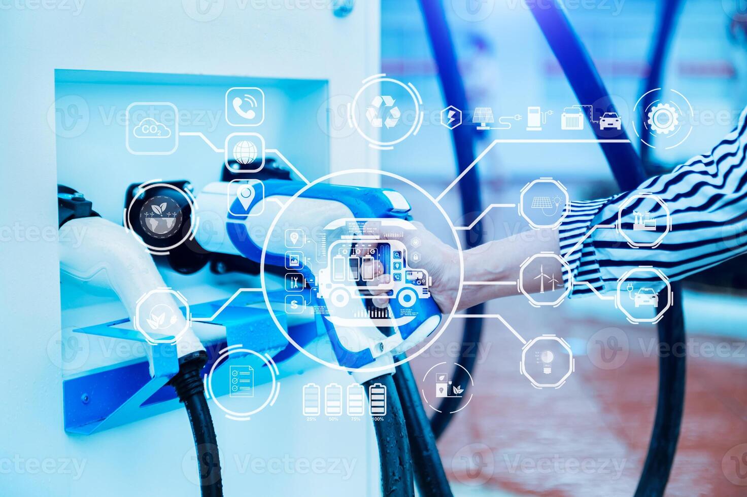 Hand plugging in a charger in an electric car socket.Electric car or ev is charging at station . with virtual icon photo