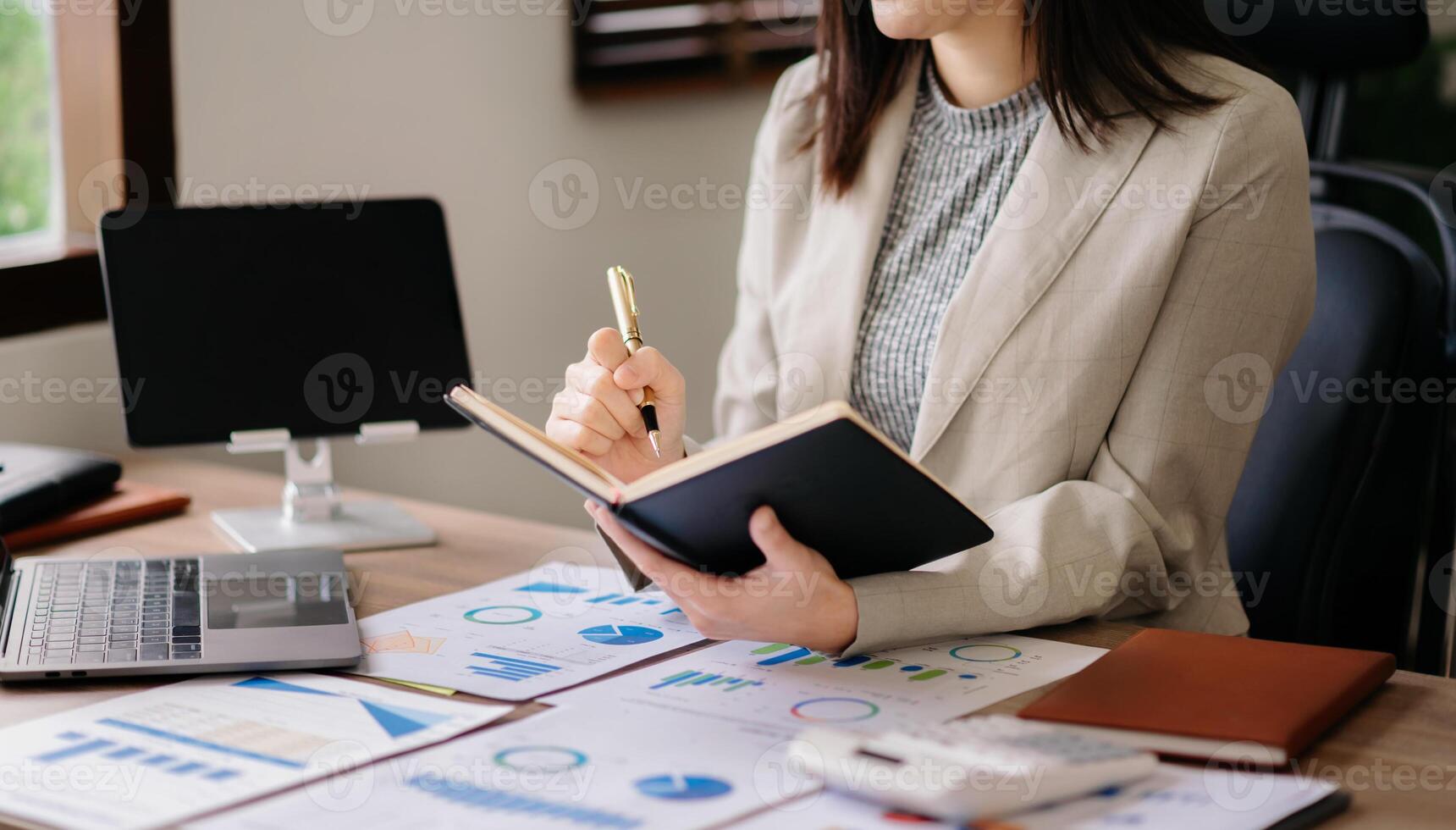 businesswoman hand working with new modern computer and writing on the notepad strategy diagram as concept morning light photo