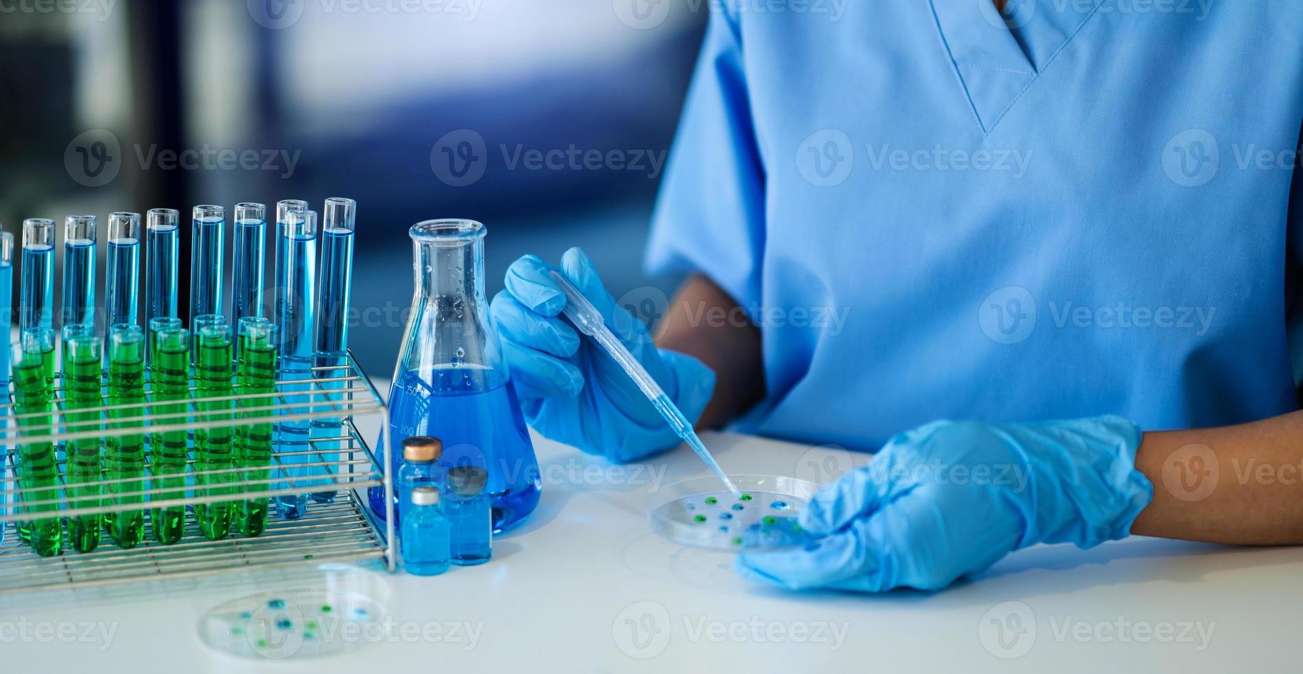 Female scientist researcher conducting an experiment working in the chemical laboratory. virus photo