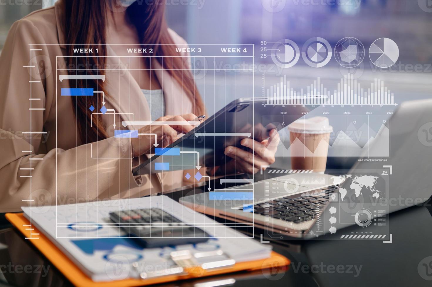 Businessman hand Project manager working and update tasks and Gantt chart scheduling virtual diagram.with smart phone, tablet and laptop in office. photo
