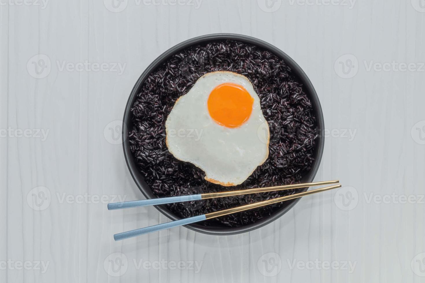 comida saludable arroz negro en un tazón tiene huevo frito foto