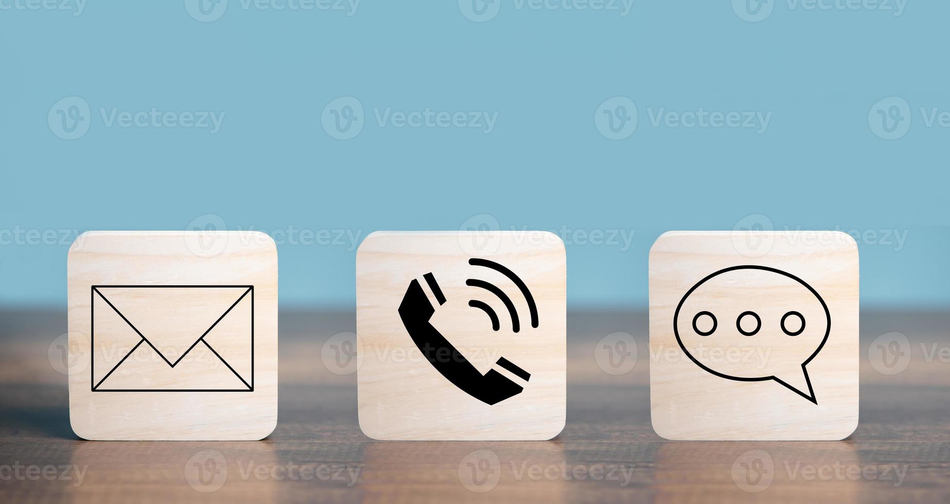 Customer Contact Us Service icons  with Mail, Email, Telephone, Messages on the square wooden  put on the desk. photo