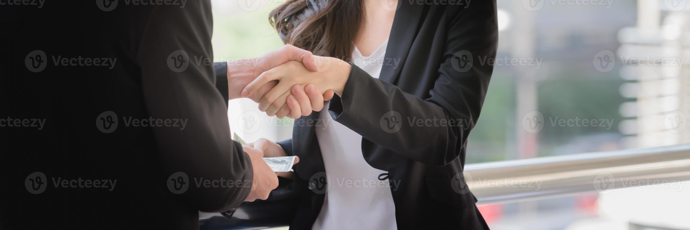 Success Deal business, Business people Shaking Hands And Receiving Money. photo