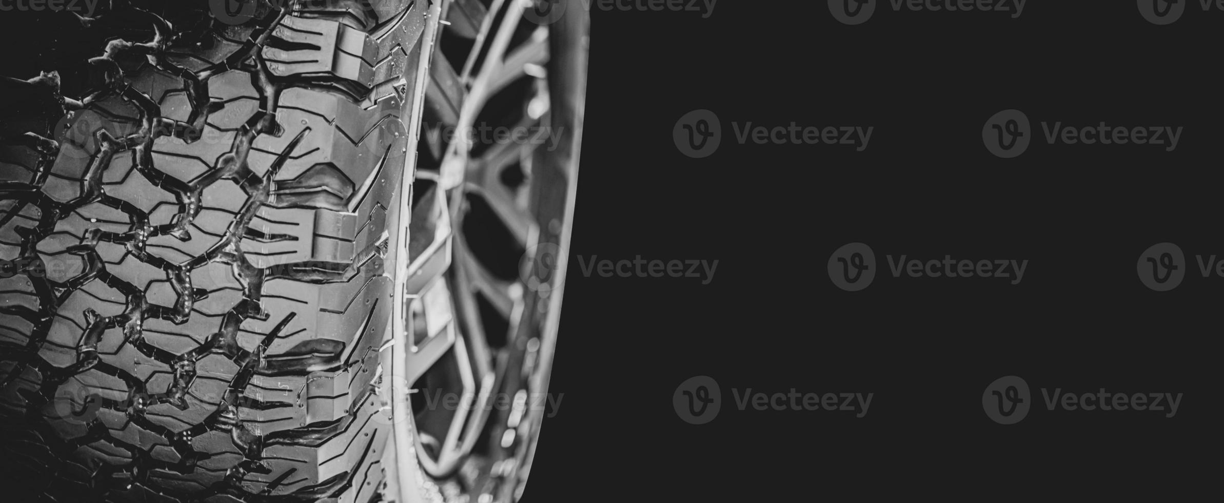 High performance automotive tire tread on black background with copy space for banner, Car Maintenance Service. photo