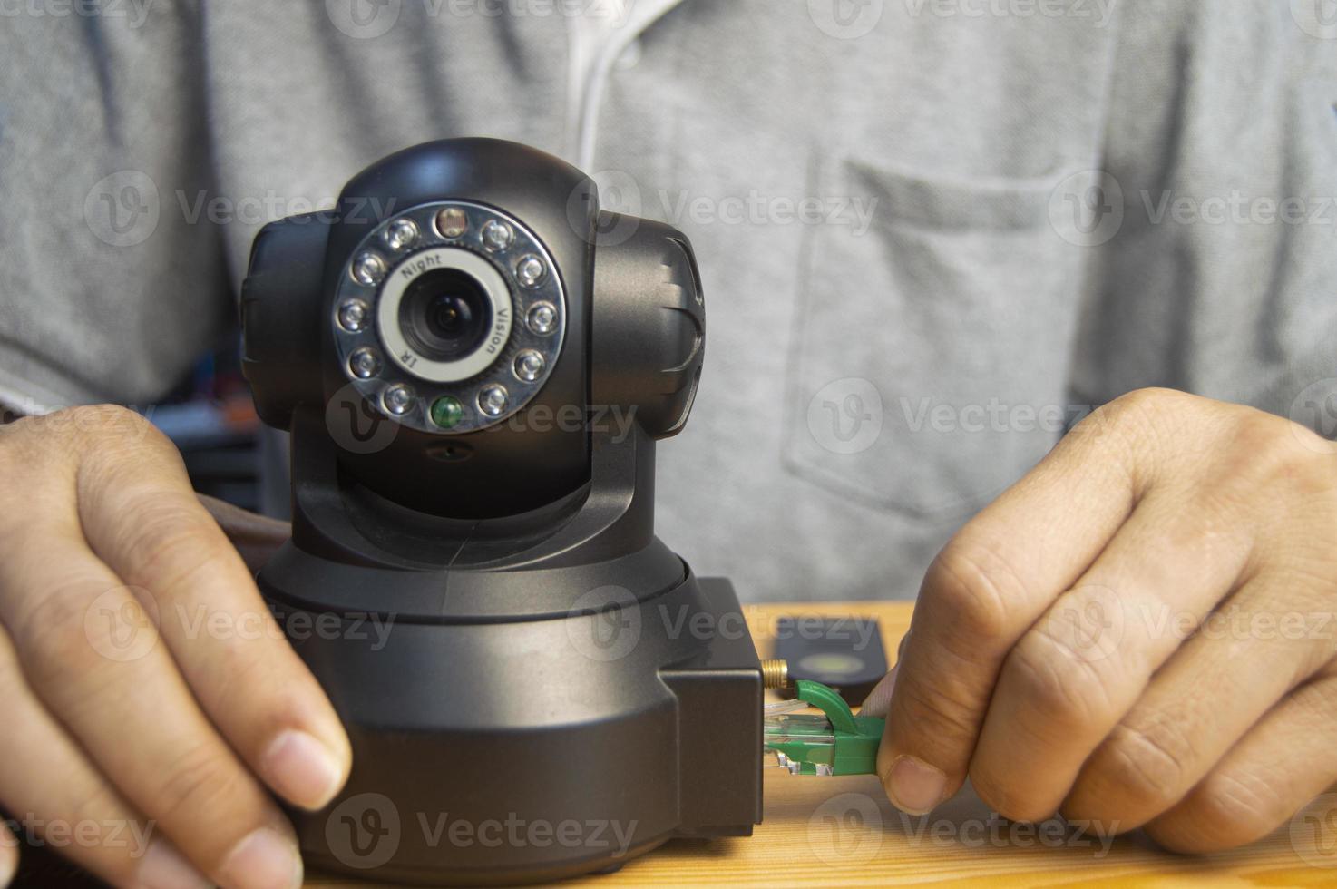 Conceptual man operating ip camera photo
