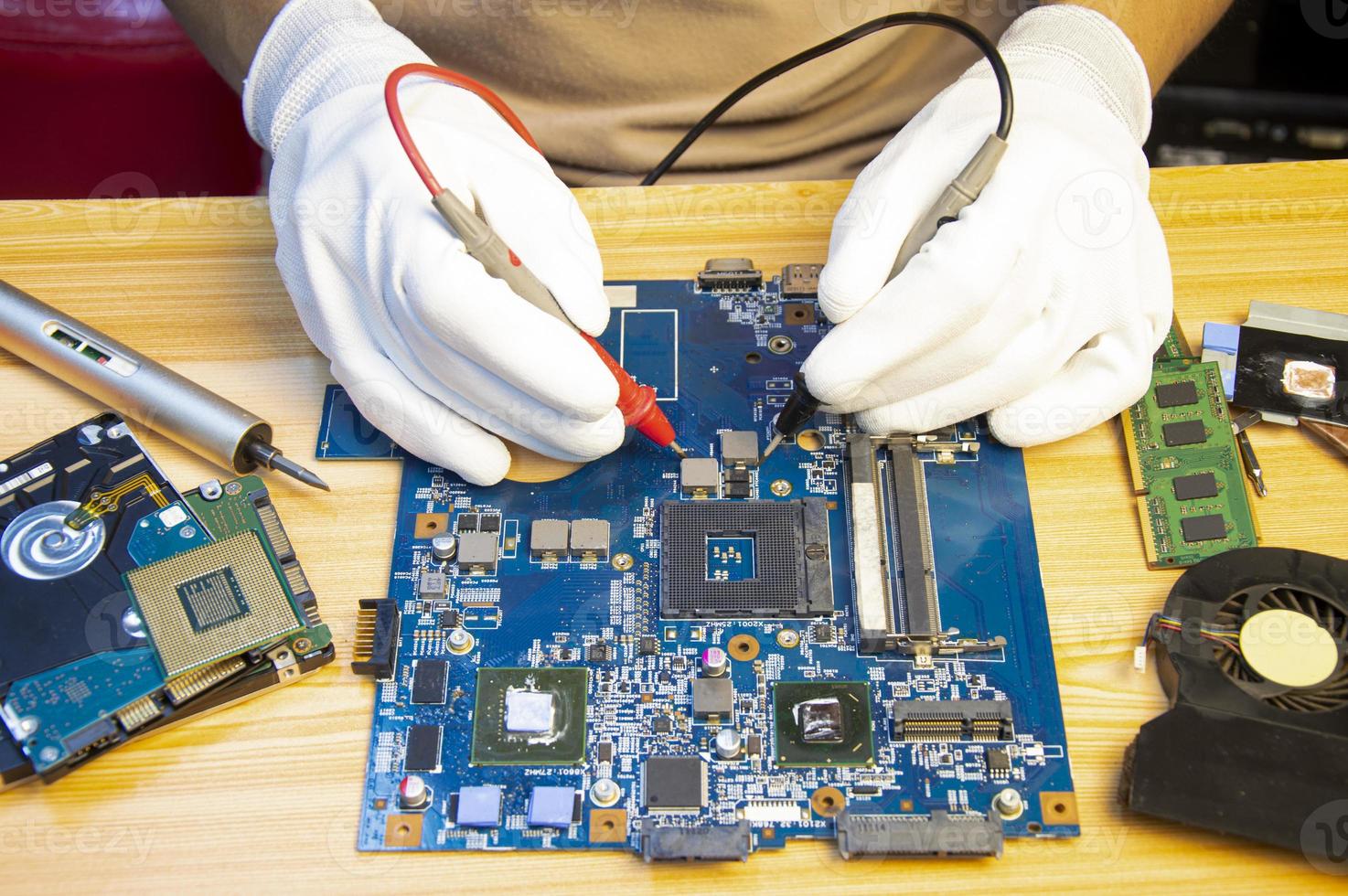 Technician repairing computer motherboard, notebook motherboard photo