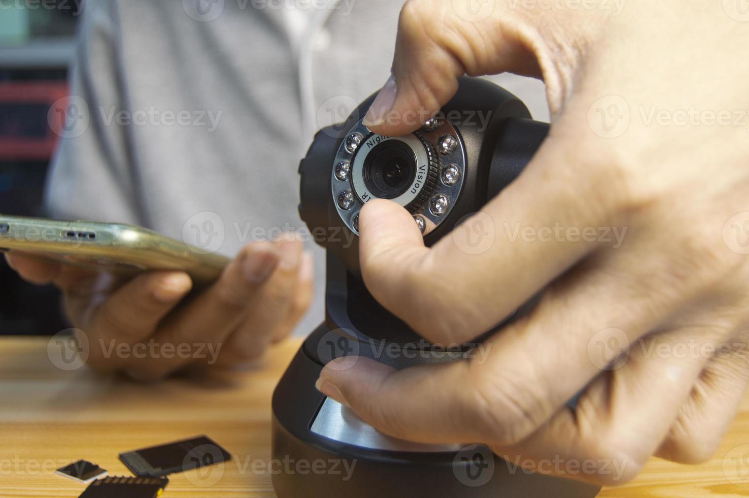 Conceptual man operating ip camera photo