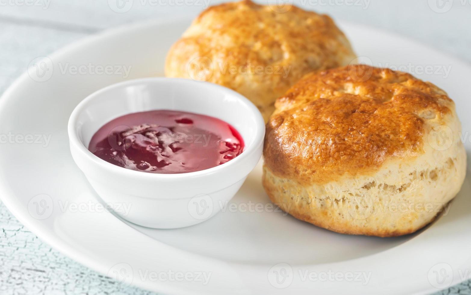 Classic scones with cream and berry jam photo