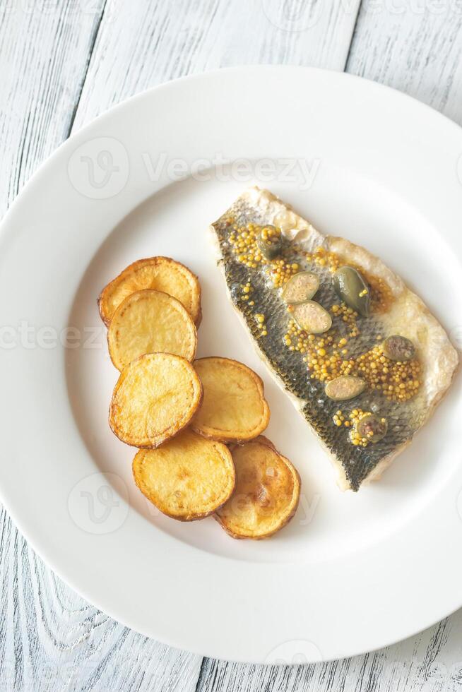 Baked sea bass with capers 14938441 Stock Photo at Vecteezy