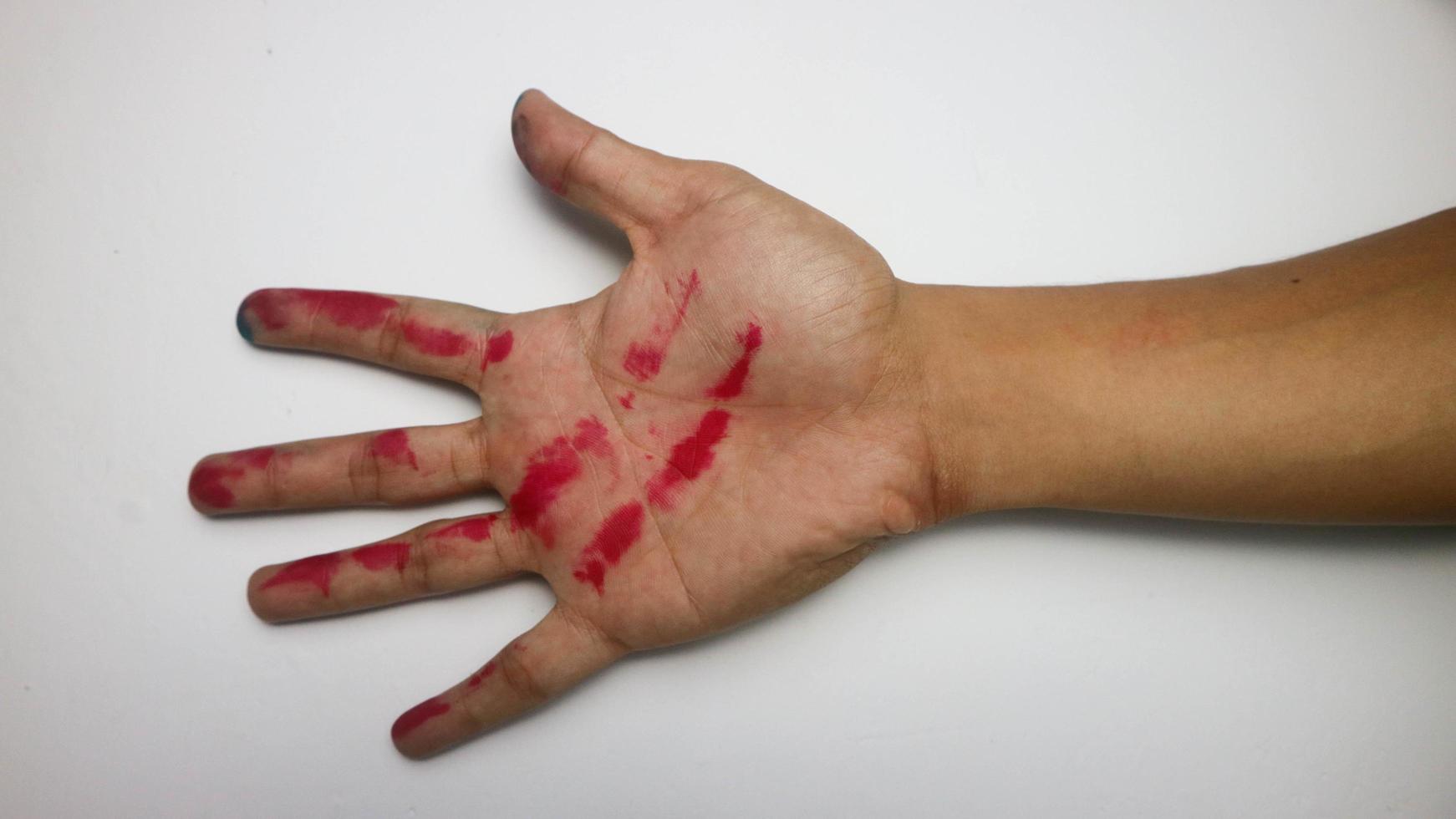 hand with red ink on a white background photo