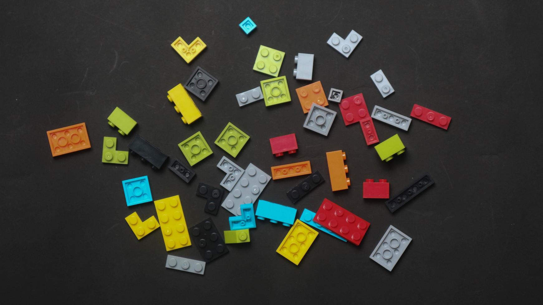 Plastic toy block on a black background photo