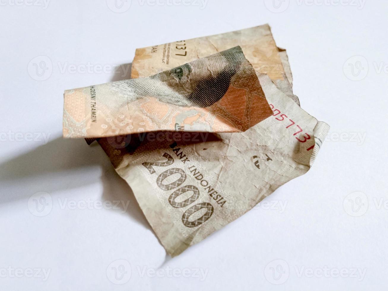 Indonesian shabby banknote with a nominal value of 2000 rupiah isolated white background photo