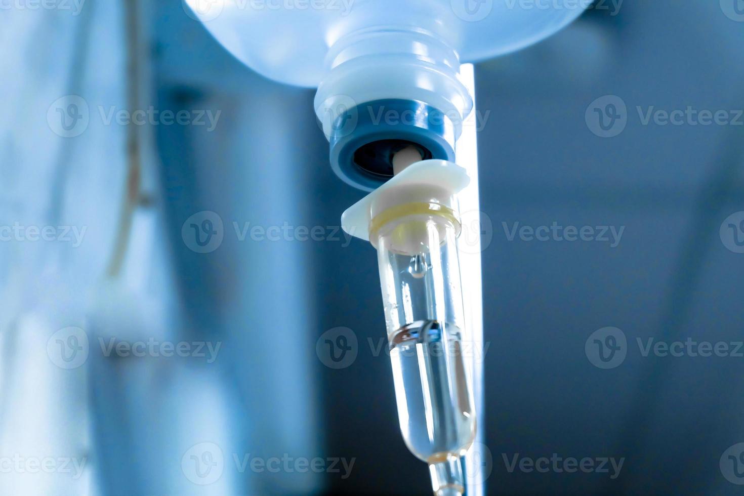 Close up IV saline solution drip for patient hospital. photo