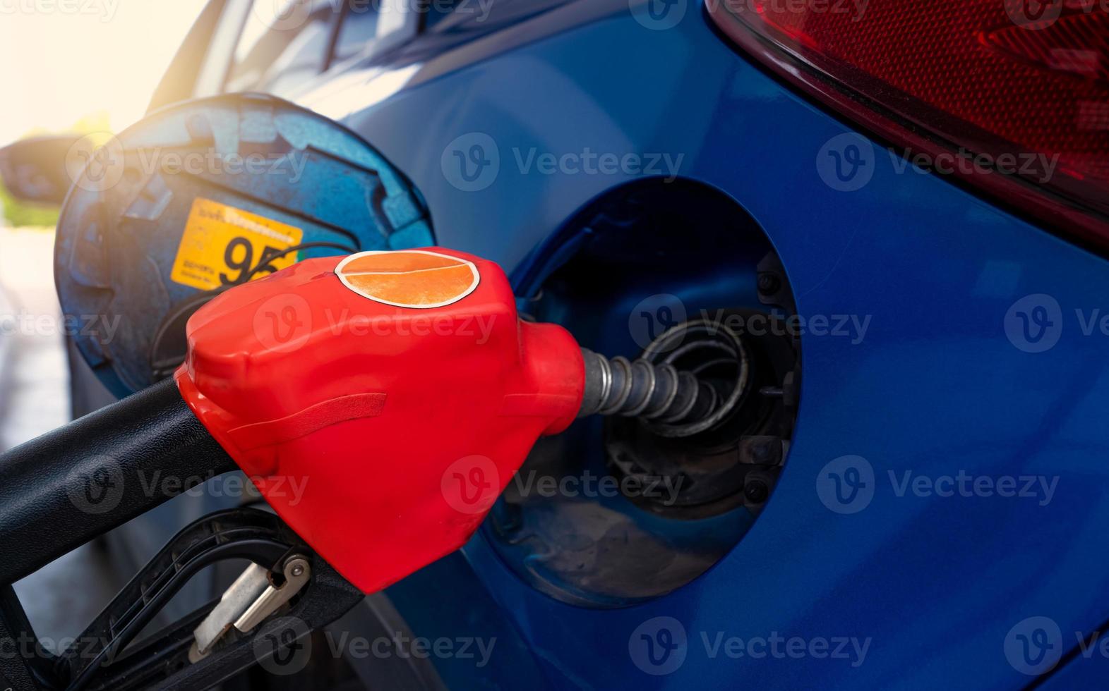 Car fueling at gas station. Refuel fill up with petrol gasoline. Petrol pump filling fuel nozzle in fuel tank of car at gas station. Petrol industry and service. Petrol price and oil crisis concept. photo