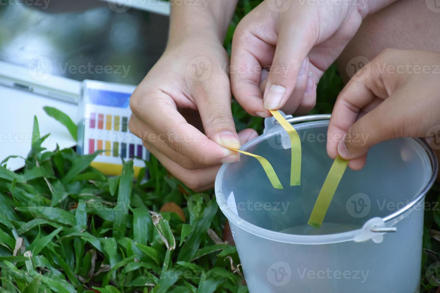 Students are experimenting and measuring the pH of water or the acidity