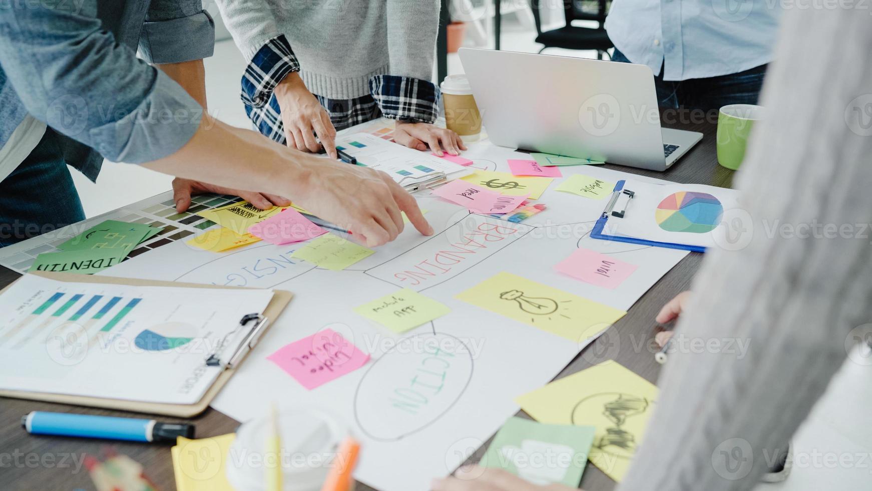 Group of casually dressed business people discussing ideas in the office. Creative professionals gathered at the meeting table for discuss the important issues of the new successful startup project. photo