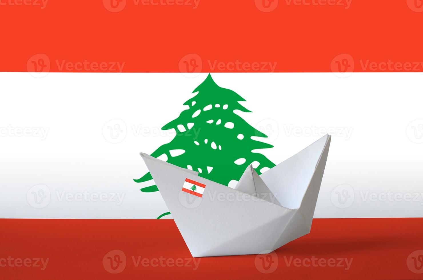 Lebanon flag depicted on paper origami ship closeup. Handmade arts concept photo