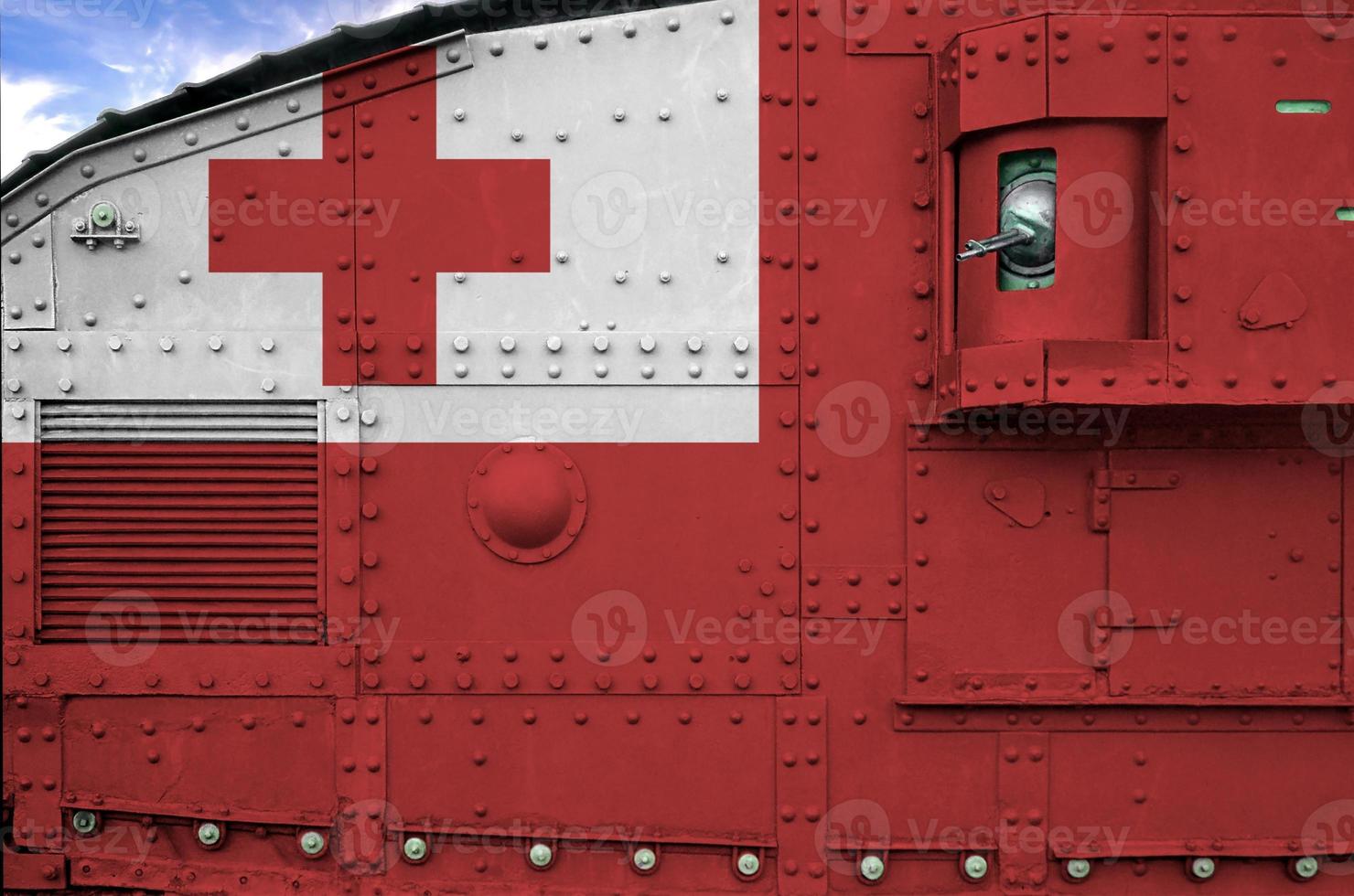 Tonga flag depicted on side part of military armored tank closeup. Army forces conceptual background photo