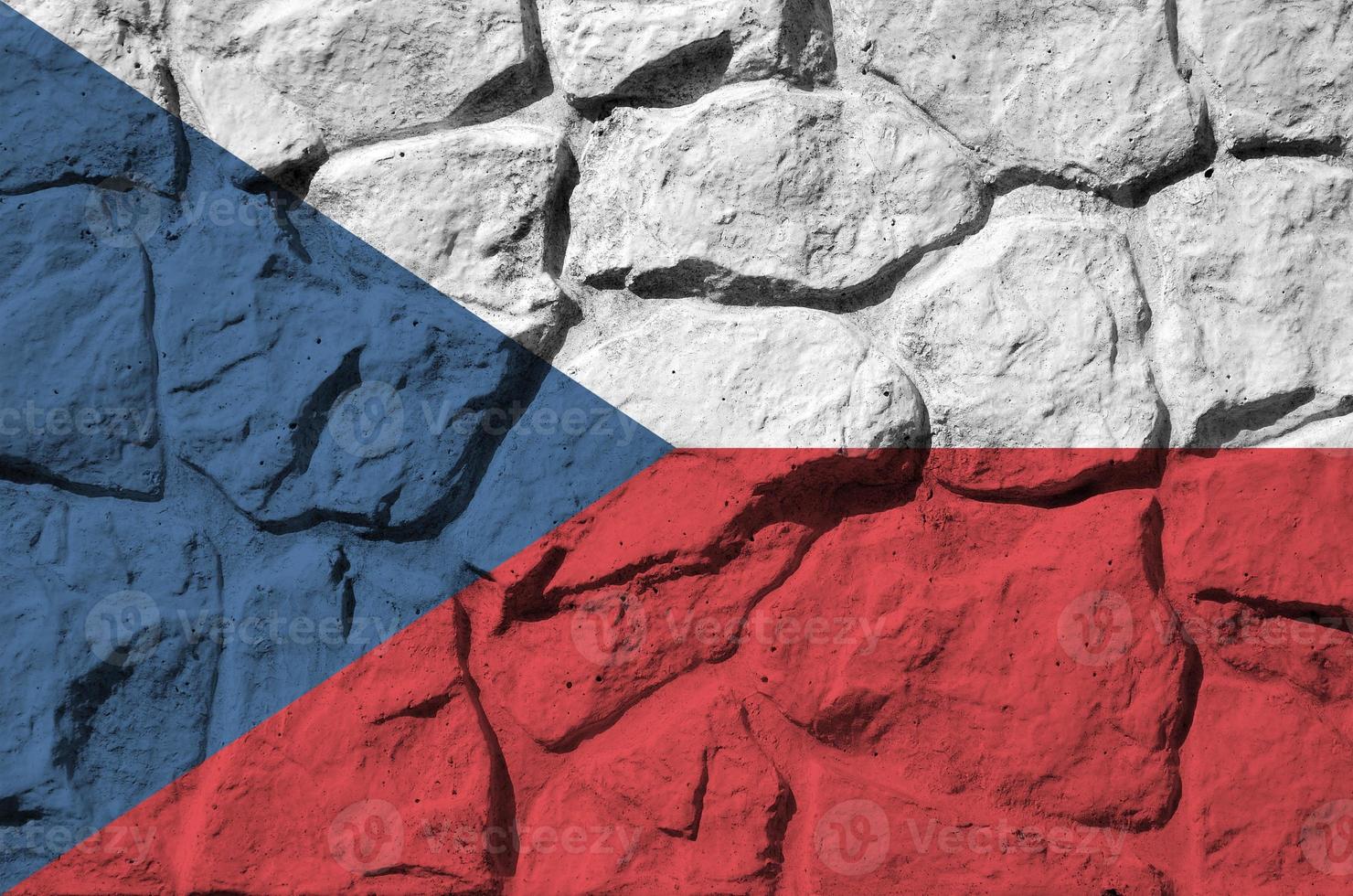 Czech flag depicted in paint colors on old stone wall closeup. Textured banner on rock wall background photo