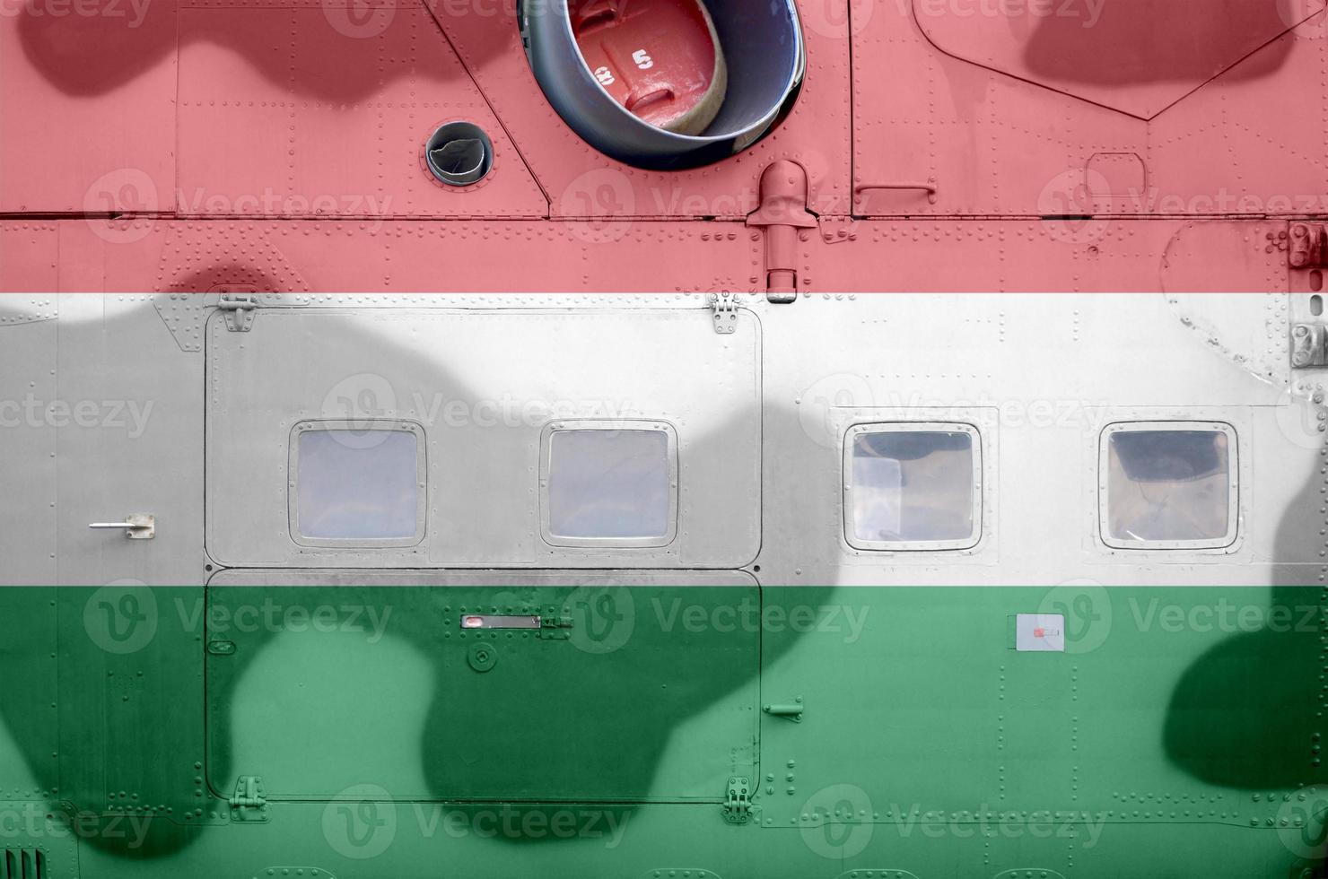 Hungary flag depicted on side part of military armored helicopter closeup. Army forces aircraft conceptual background photo
