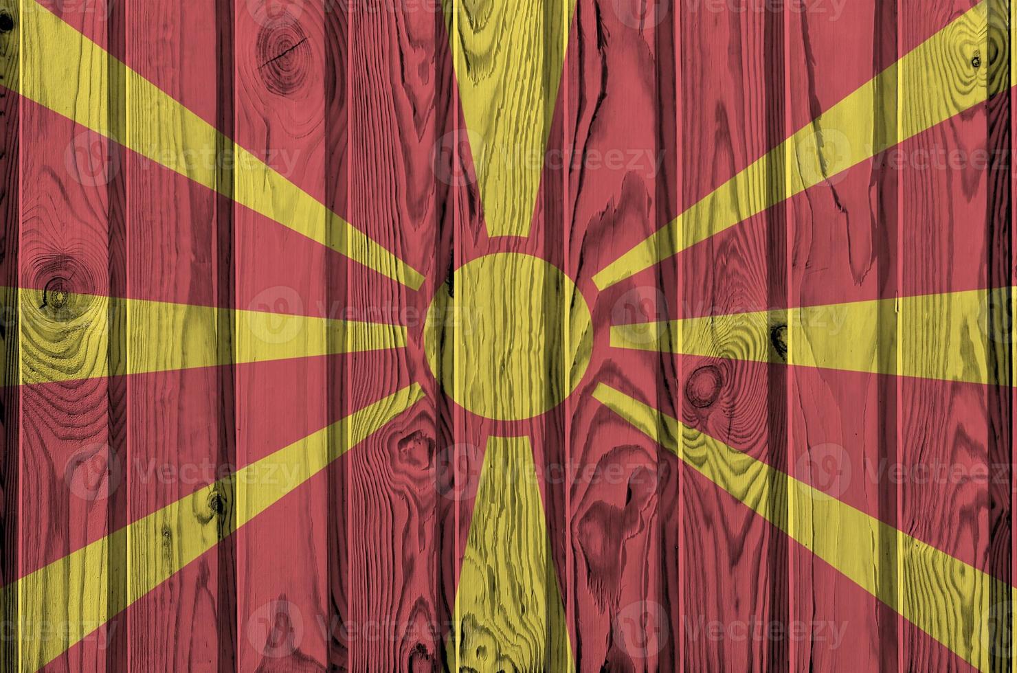 Macedonia flag depicted in bright paint colors on old wooden wall. Textured banner on rough background photo