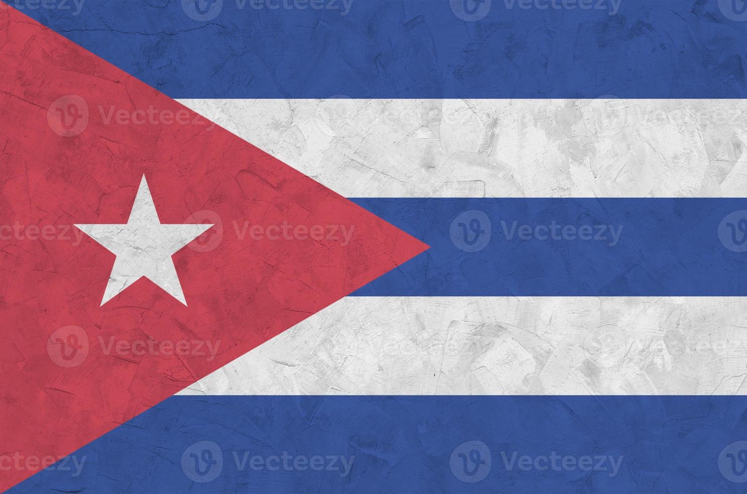 Cuba flag depicted in bright paint colors on old relief plastering wall. Textured banner on rough background photo